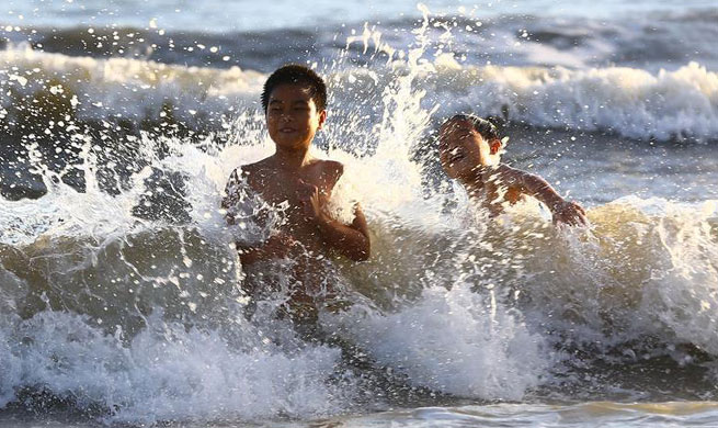 Water brings coolness to people in scorching summer